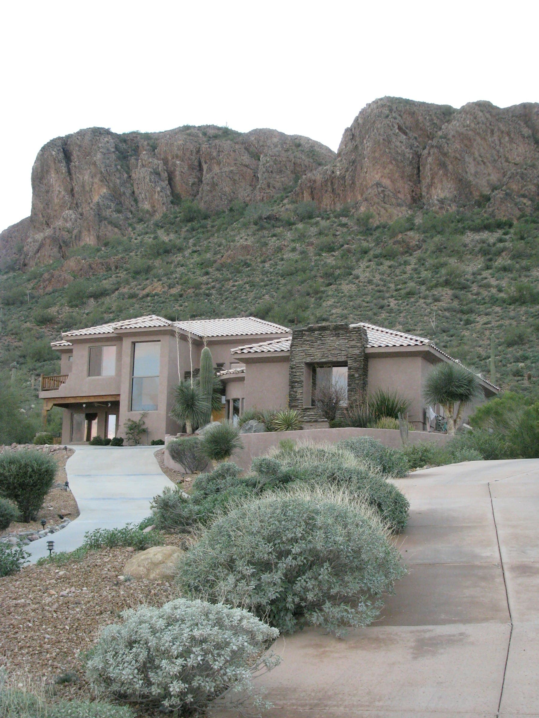 Southern Utah stucco home below red rock cliffs