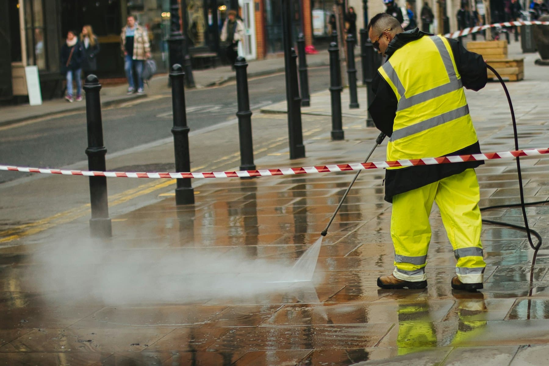 Pressure washing a paved outdoor surface
